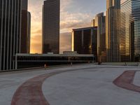 there are many tall buildings next to each other in a city setting of sunsets