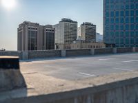 several large empty parking spaces in the city with buildings nearby in front of them -