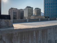 several large empty parking spaces in the city with buildings nearby in front of them -