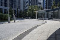 a person sitting at the bench in front of a mall that is empty of people