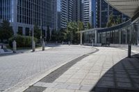 a person sitting at the bench in front of a mall that is empty of people