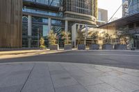 some big city buildings near a bus stop and a park bench with benches on it