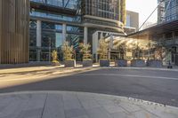 some big city buildings near a bus stop and a park bench with benches on it