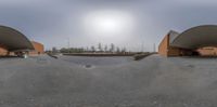 a 360 - spherical image of two skateboards coming in for a landing at a skate park