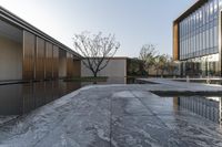 the inside courtyard of the contemporary building, with water and glass walls surrounding the walkway