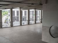 a view from inside an empty building of an empty room with metal accents around the area