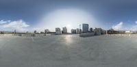 a 360 - view of a city with a skate park in the foreground and a few buildings