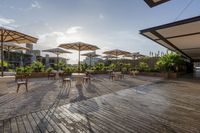 an outdoor patio with tables and chairs and umbrellas for shade and sunlight protection on the area