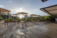 an outdoor patio with tables and chairs and umbrellas for shade and sunlight protection on the area