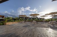 an outdoor patio with tables and chairs and umbrellas for shade and sunlight protection on the area