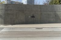 a building is constructed out of concrete on the corner of a street with no traffic