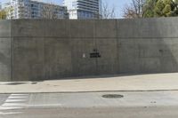 a building is constructed out of concrete on the corner of a street with no traffic