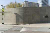 a building is constructed out of concrete on the corner of a street with no traffic