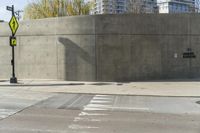 a building is constructed out of concrete on the corner of a street with no traffic