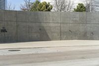 a building is constructed out of concrete on the corner of a street with no traffic