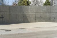 a building is constructed out of concrete on the corner of a street with no traffic