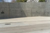 a building is constructed out of concrete on the corner of a street with no traffic