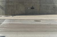 a building is constructed out of concrete on the corner of a street with no traffic