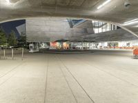 a building has a big concrete structure in the middle of it, with benches and stairs to the side