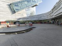 a person is walking around near a water hole at a restaurant area under a glass roof