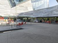 a person is walking around near a water hole at a restaurant area under a glass roof