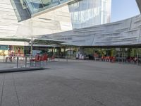 a person is walking around near a water hole at a restaurant area under a glass roof