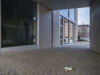 a couple of yellow boxes are next to a building with windows and a clock on it