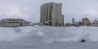 the snow covered parking lot in front of this building is completely white snowing on the ground