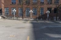 several parking meters and four steps in front of a building in an empty lot with some trees