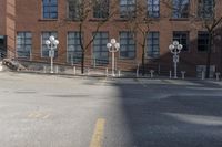 several parking meters and four steps in front of a building in an empty lot with some trees