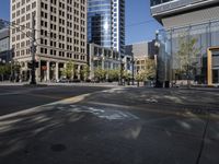 an empty city street and its yellow painted markings on the pavement, with people walking in the middle