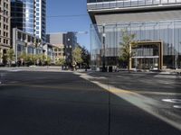 an empty city street and its yellow painted markings on the pavement, with people walking in the middle