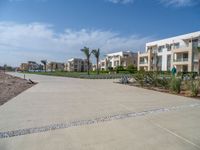 an image of the empty road near the apartments in the background of the blue sky