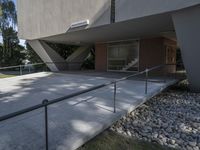 a building with a few windows, stairs and a walkway in front of it,