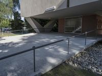 a building with a few windows, stairs and a walkway in front of it,