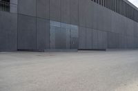 a person wearing a face mask walking across an empty street with a skateboard in the foreground