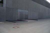 a person wearing a face mask walking across an empty street with a skateboard in the foreground