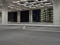 an empty parking garage and a large building in the background at night or day in a large city