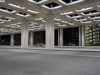 an empty parking garage and a large building in the background at night or day in a large city