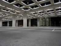 an empty parking garage and a large building in the background at night or day in a large city