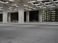 an empty parking garage and a large building in the background at night or day in a large city