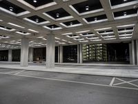 an empty parking garage and a large building in the background at night or day in a large city