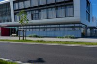 an empty street and an office building in the distance on a clear day in europe