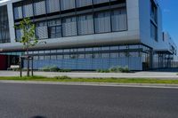 an empty street and an office building in the distance on a clear day in europe