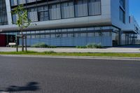 an empty street and an office building in the distance on a clear day in europe