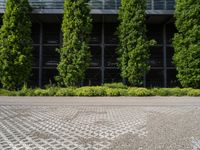 there is a large concrete and brick paved parking lot with a few trees in the background