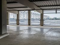 there is an empty floor with large windows at this level of the station with high power lines outside