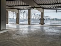 there is an empty floor with large windows at this level of the station with high power lines outside