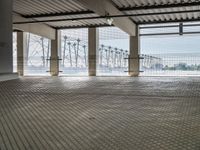 there is an empty floor with large windows at this level of the station with high power lines outside