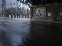 a wet street that looks like it's raining down from the sky and in front of buildings